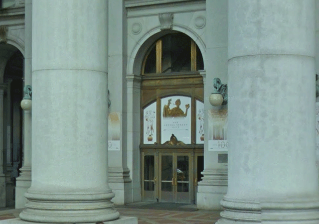 A multiple door entrance located on street level. The two doors on the left are open.