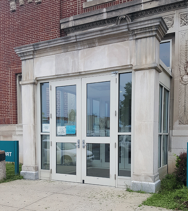 An entrance containing two doors. The entrance is on the street level.