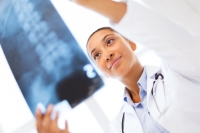 Female Doctor reviewing x-ray of a spine