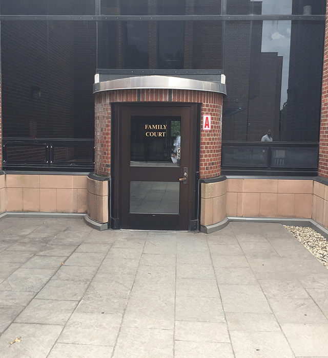 A single door entrance to Family Court. The door is accessed directly from the sidewalk.