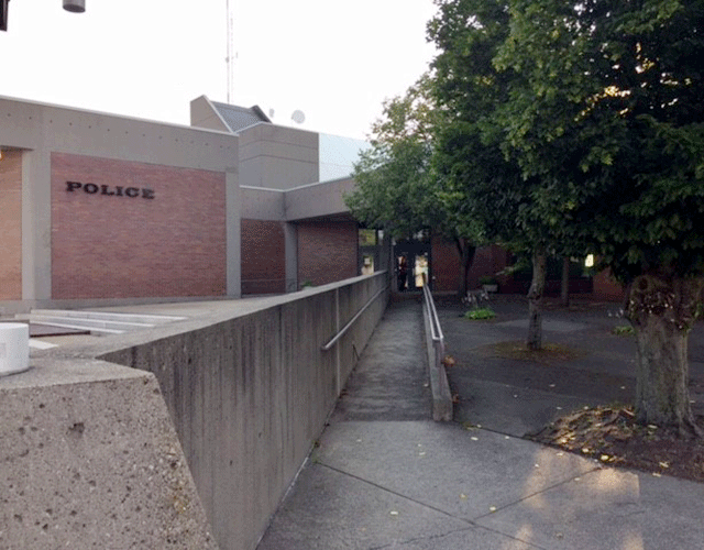 A long ramp leading to the court facility. The building has 'Police' posted on the side of the building.