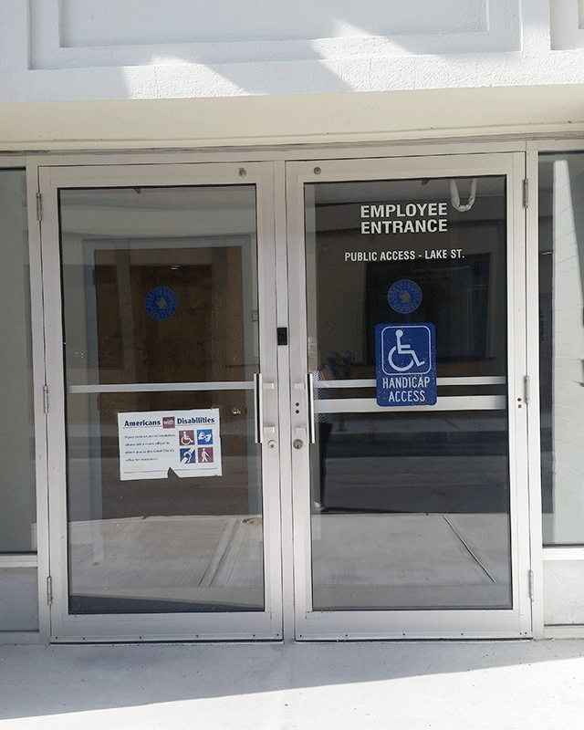 There are two doors marked as employee entrance. The door to the right has a sign that states it is also the ADA-accessible entrance.