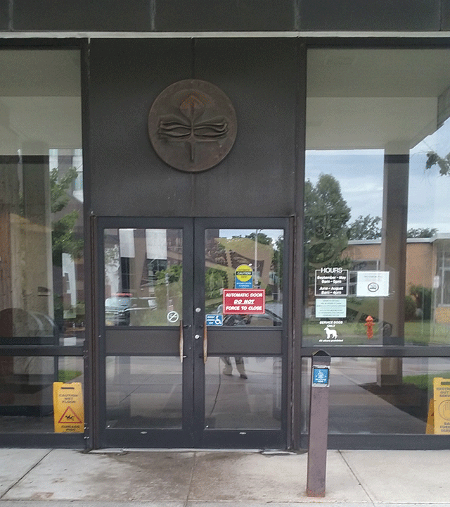 The courthouse has a double door entrance. The right door has ADA signage and a  warning that the right door is automatic. There is a push button to the right of the right door that will open it up.