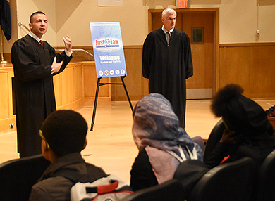 Photo of Judge Valleriani and Judge Demarco speaking with students