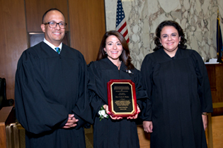 3 Judges, middle one holding plaque