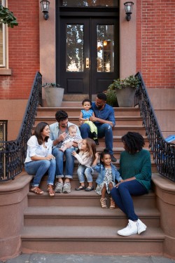 Diverse people of different families spending time on front stoop